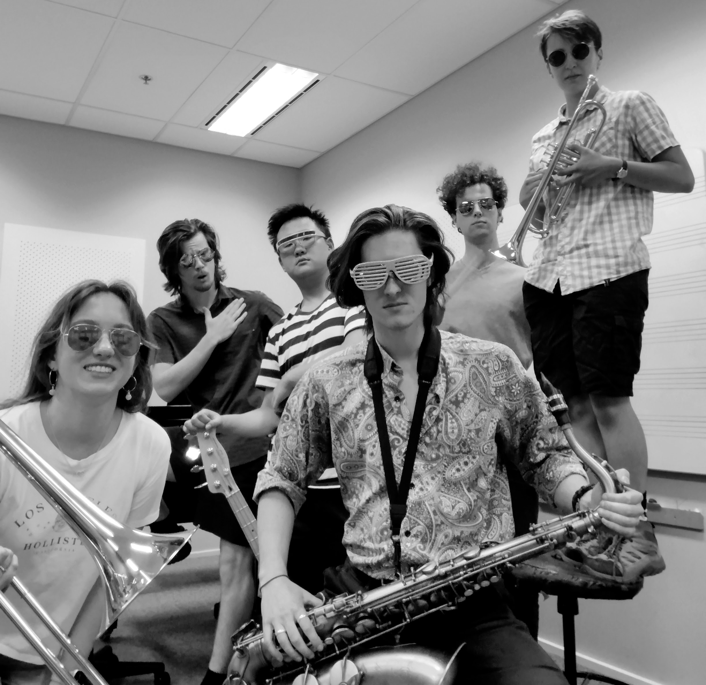 People wearing sunglasses and holding musical instruments.